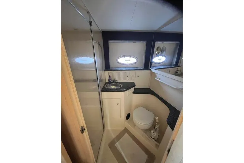  Yacht Photos Pics Bathroom interior of 1999 Carver 404 Cockpit Motor Yacht, featuring sink, toilet, and shower.