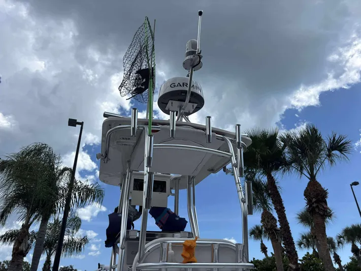  Yacht Photos Pics 2007 Andros Tarpon 26 boat tower with radar, palm trees, and cloudy sky.