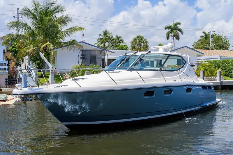  Yacht Photos Pics 2013 Tiara Yachts 3900 Sovran docked near palm trees and waterfront homes.