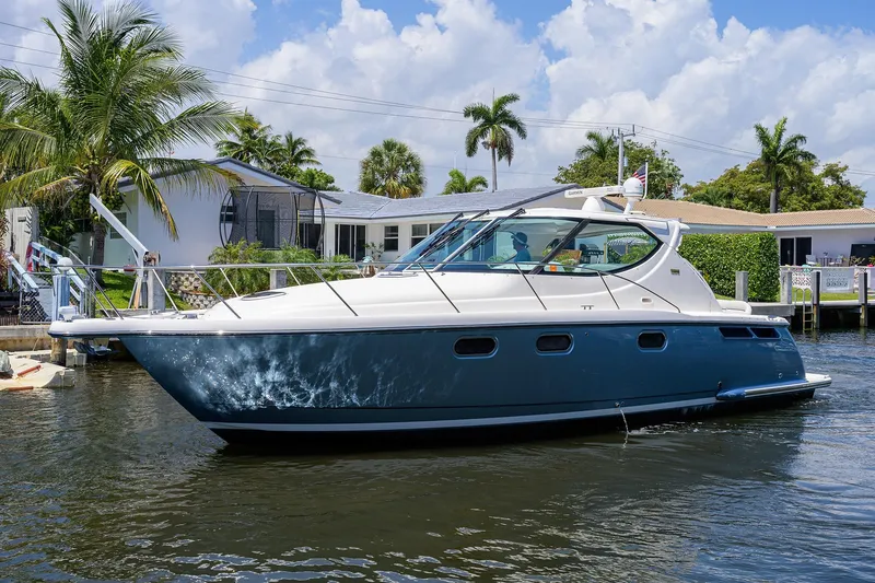  Yacht Photos Pics 2013 Tiara Yachts 3900 Sovran cruising on a sunny day near waterfront homes.