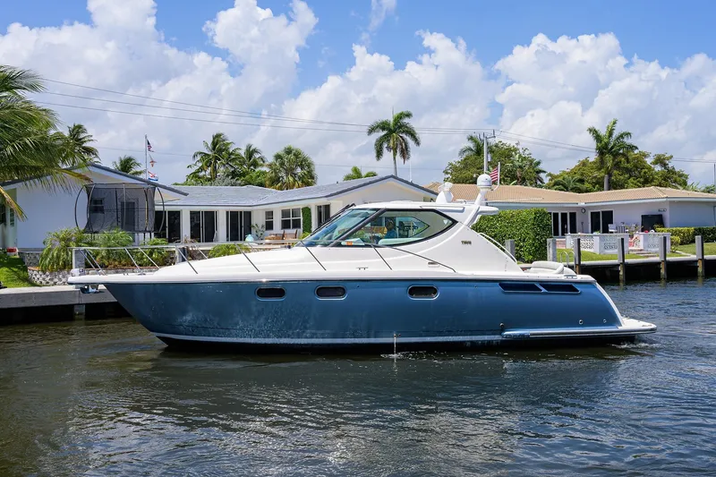  Yacht Photos Pics 2013 Tiara Yachts 3900 Sovran cruising on a sunny day near waterfront homes.