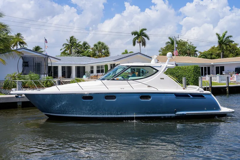  Yacht Photos Pics 2013 Tiara Yachts 3900 Sovran cruising on a sunny day near waterfront homes.