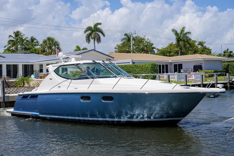  Yacht Photos Pics 2013 Tiara Yachts 3900 Sovran cruising on a sunny day near waterfront homes.