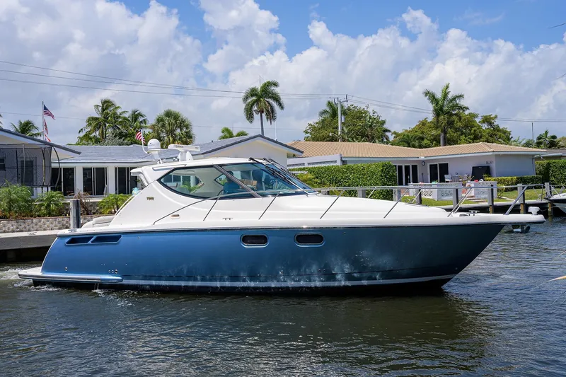  Yacht Photos Pics 2013 Tiara Yachts 3900 Sovran cruising on a sunny day near waterfront homes.