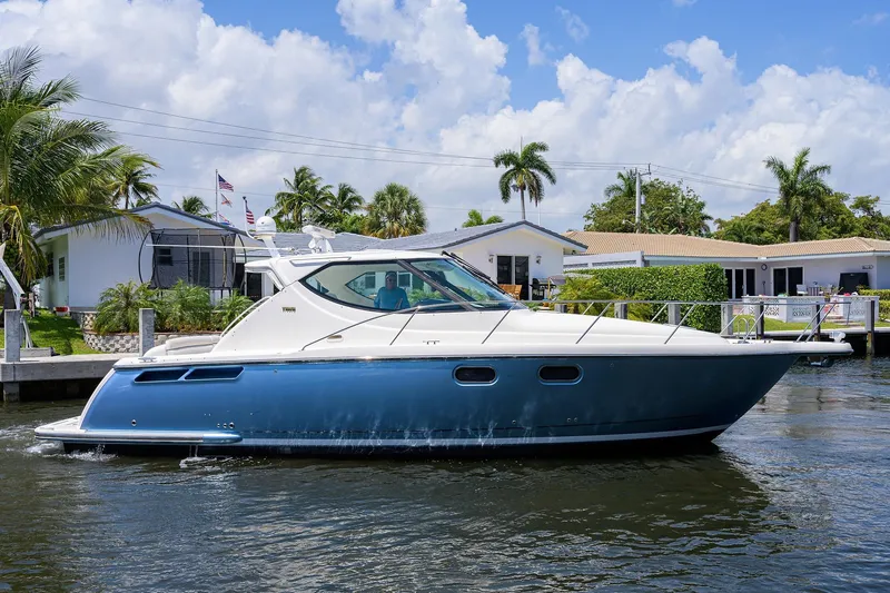  Yacht Photos Pics 2013 Tiara Yachts 3900 Sovran cruising on a sunny day near waterfront homes.