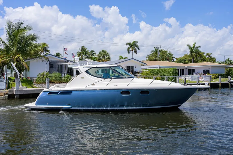  Yacht Photos Pics 2013 Tiara Yachts 3900 Sovran cruising on a sunny day near waterfront homes.
