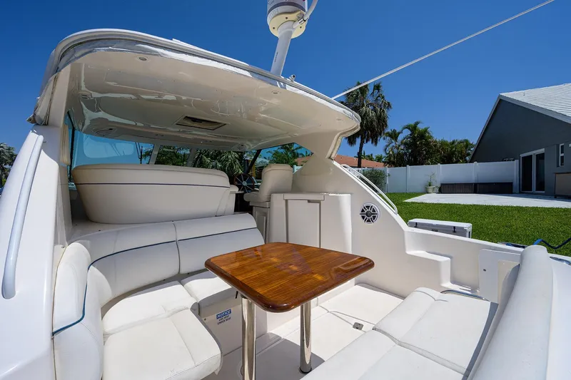  Yacht Photos Pics 2013 Tiara Yachts 3900 Sovran interior with white seating and wooden table.