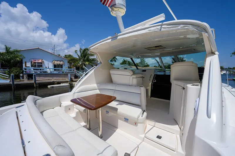  Yacht Photos Pics 2013 Tiara Yachts 3900 Sovran with spacious deck and seating, docked by waterfront homes.