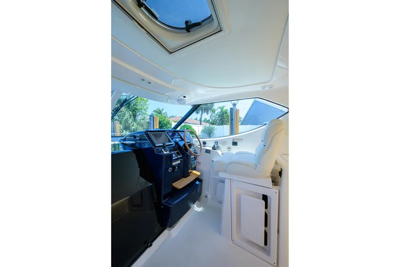  Yacht Photos Pics Interior of 2013 Tiara Yachts 3900 Sovran, featuring helm and luxurious seating.