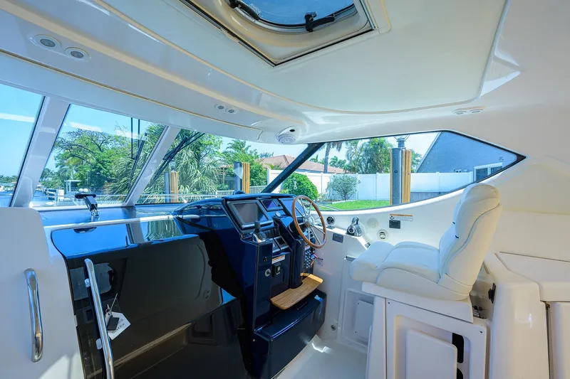  Yacht Photos Pics Luxurious interior of 2013 Tiara Yachts 3900 Sovran with sleek helm and plush seating.