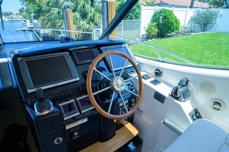  Yacht Photos Pics Helm of 2013 Tiara Yachts 3900 Sovran with modern navigation equipment and wooden steering wheel.