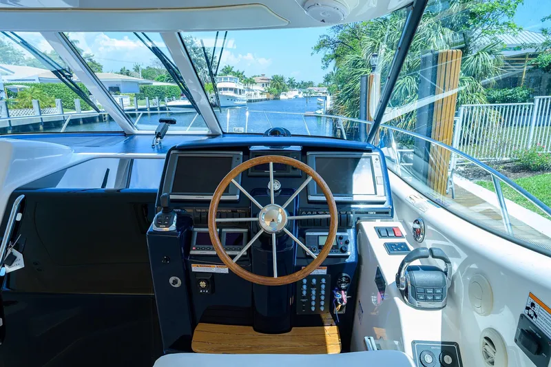  Yacht Photos Pics Cockpit of 2013 Tiara Yachts 3900 Sovran with steering wheel and navigation equipment.