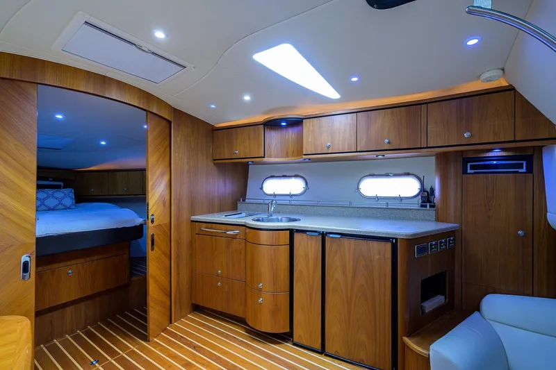  Yacht Photos Pics Interior of 2013 Tiara Yachts 3900 Sovran, featuring a modern kitchen and cozy bedroom.