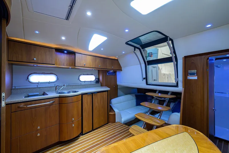  Yacht Photos Pics Luxurious interior of 2013 Tiara Yachts 3900 Sovran with modern kitchen and seating area.