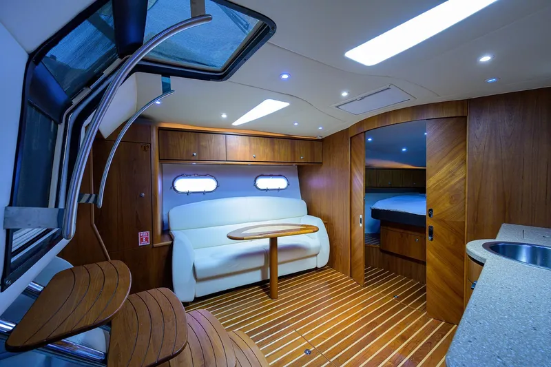  Yacht Photos Pics Luxurious 2013 Tiara Yachts 3900 Sovran interior with elegant wood finish and cozy seating area.