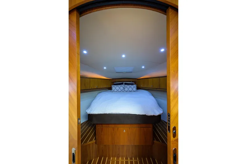  Yacht Photos Pics Luxurious cabin interior of 2013 Tiara Yachts 3900 Sovran with cozy bed and wooden accents.