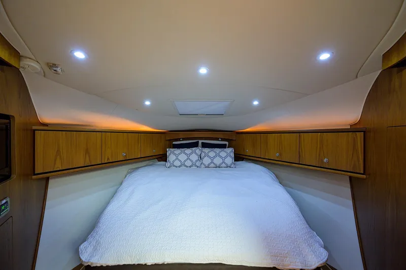  Yacht Photos Pics Luxurious cabin interior of 2013 Tiara Yachts 3900 Sovran with cozy bedding and ambient lighting.