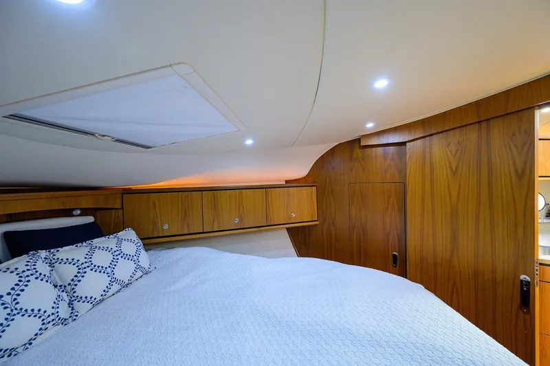  Yacht Photos Pics Cozy cabin interior of 2013 Tiara Yachts 3900 Sovran with wood paneling and soft lighting.