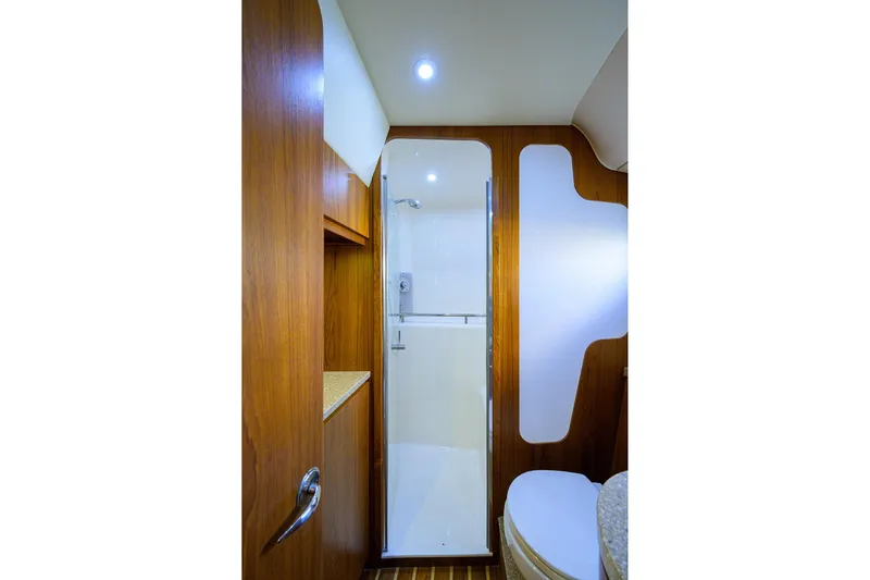  Yacht Photos Pics 2013 Tiara Yachts 3900 Sovran bathroom with wooden cabinetry and modern shower.