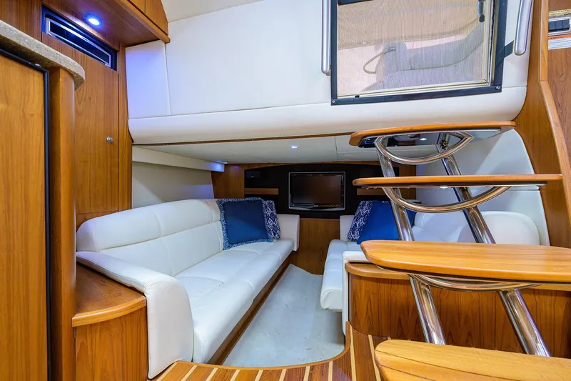  Yacht Photos Pics Luxurious interior of 2013 Tiara Yachts 3900 Sovran with white seating and wooden accents.