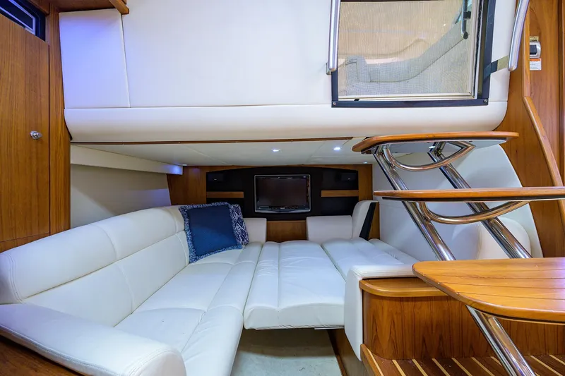 Yacht Photos Pics Luxurious interior of 2013 Tiara Yachts 3900 Sovran with white leather seating and wooden accents.