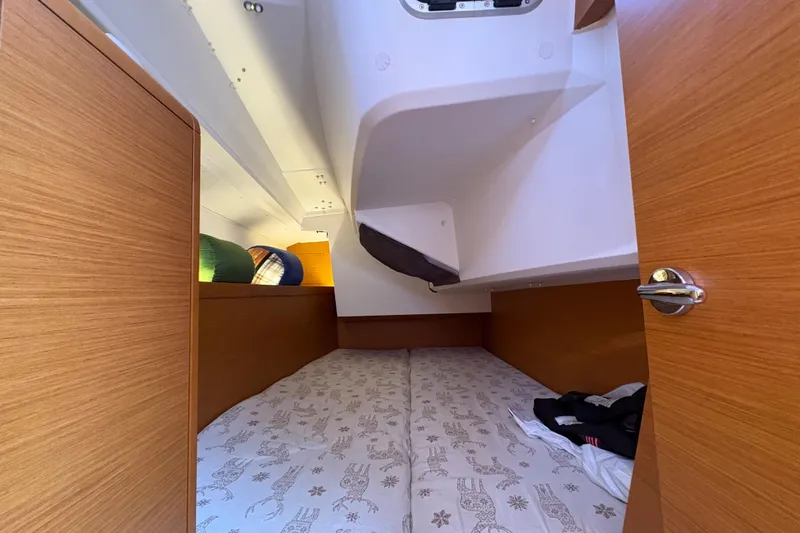 Alpha-joy Yacht Photos Pics Cozy cabin interior of 2017 Jeanneau Sun Odyssey 349 sailboat with wooden finish.