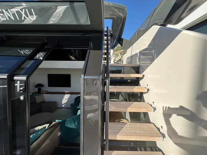  Yacht Photos Pics 2022 Bluegame BGX70 yacht interior with modern staircase and seating area.