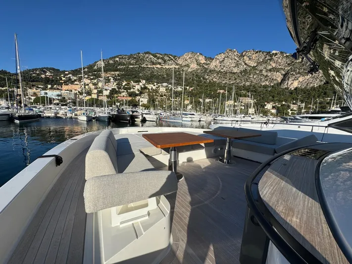  Yacht Photos Pics Luxurious 2022 Bluegame BGX70 yacht with elegant seating, docked in scenic marina.