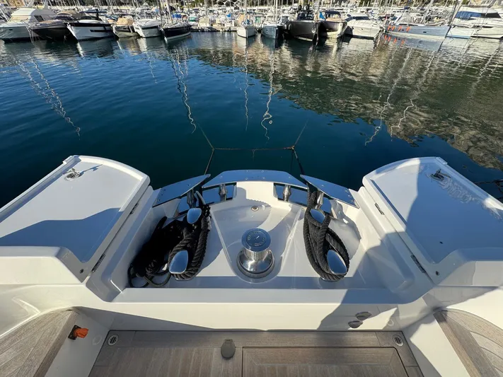  Yacht Photos Pics 2022 Bluegame BGX70 yacht stern view at marina with moored boats.