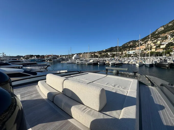  Yacht Photos Pics Luxurious 2022 Bluegame BGX70 yacht docked in a scenic marina.