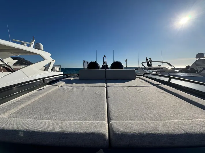  Yacht Photos Pics 2022 Bluegame BGX70 yacht deck with sun loungers under a clear blue sky.