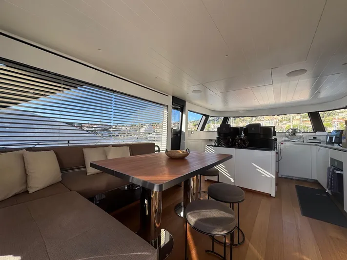  Yacht Photos Pics Luxurious interior of 2022 Bluegame BGX70 yacht with modern seating and dining area.