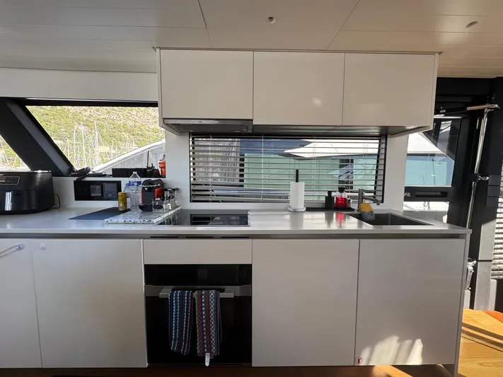  Yacht Photos Pics Modern kitchen interior on 2022 Bluegame BGX70 yacht, featuring sleek cabinetry and appliances.