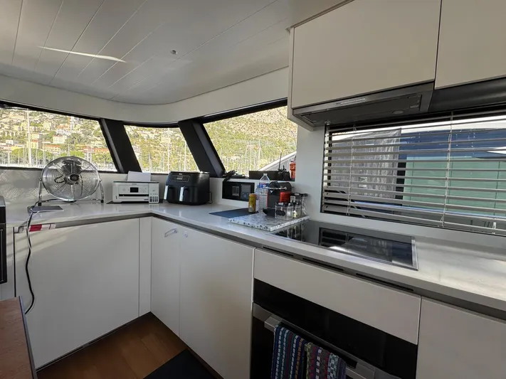  Yacht Photos Pics Modern kitchen interior on 2022 Bluegame BGX70 yacht with sleek appliances and panoramic windows.