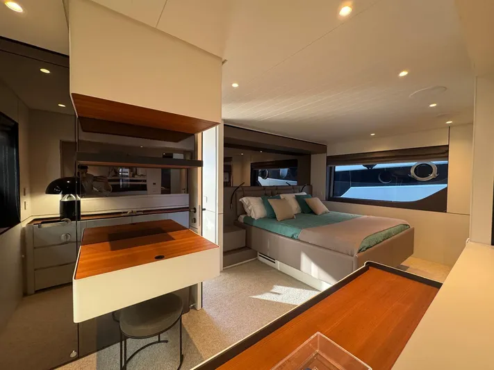  Yacht Photos Pics Luxurious interior of 2022 Bluegame BGX70 yacht with modern bedroom and workspace.
