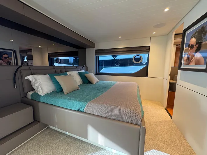  Yacht Photos Pics Luxurious bedroom interior of 2022 Bluegame BGX70 yacht with modern decor and large windows.