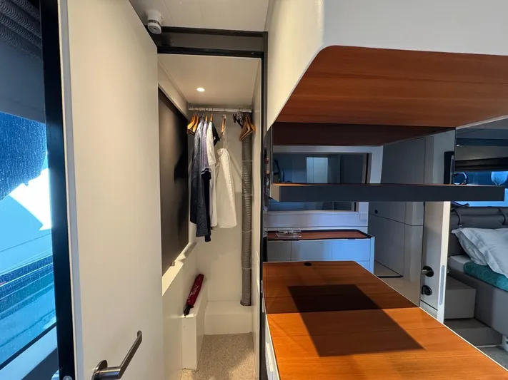  Yacht Photos Pics Interior of 2022 Bluegame BGX70 yacht with modern closet and wooden surfaces.