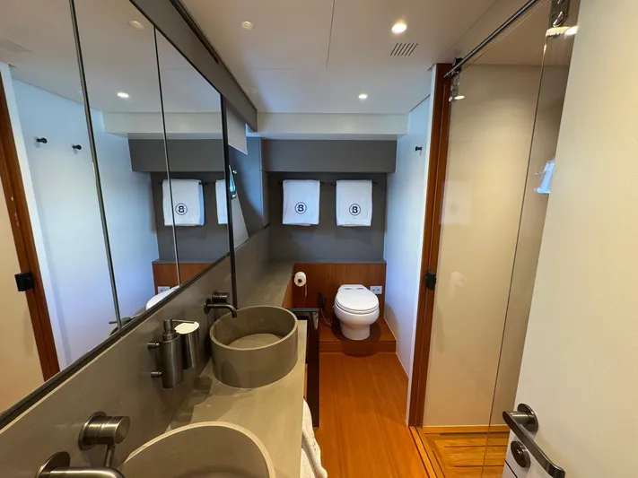  Yacht Photos Pics Luxurious bathroom in 2022 Bluegame BGX70 yacht with modern fixtures and elegant design.