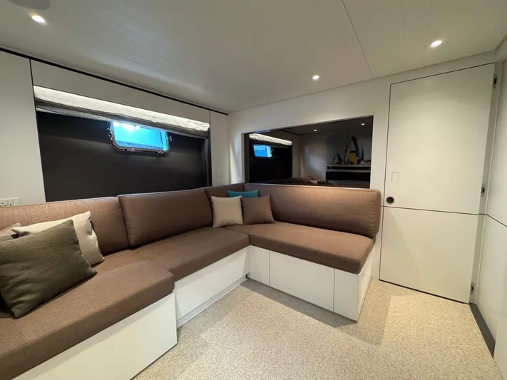  Yacht Photos Pics Luxurious interior of 2022 Bluegame BGX70 yacht with modern seating and window view.