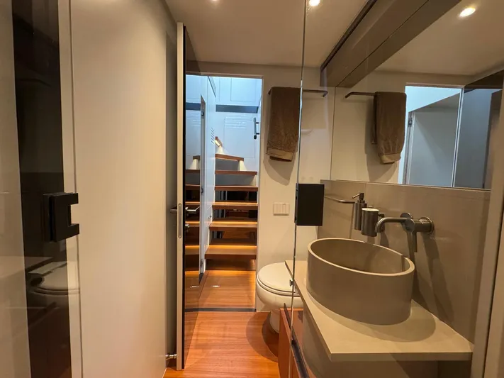  Yacht Photos Pics Modern bathroom interior on 2022 Bluegame BGX70 yacht, featuring sleek design and wooden flooring.