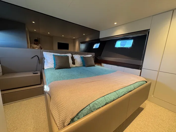  Yacht Photos Pics Luxurious cabin interior of 2022 Bluegame BGX70 yacht with modern bedding and ambient lighting.