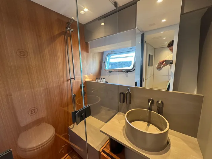  Yacht Photos Pics Modern bathroom interior on 2022 Bluegame BGX70 yacht, featuring sleek fixtures and wooden accents.