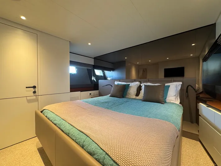  Yacht Photos Pics Luxurious bedroom interior of 2022 Bluegame BGX70 yacht with modern design and cozy bedding.