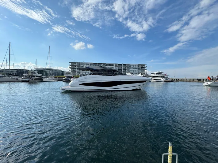  Yacht Photos Pics 2023 Princess V50 Open yacht docked in a marina under a clear blue sky.