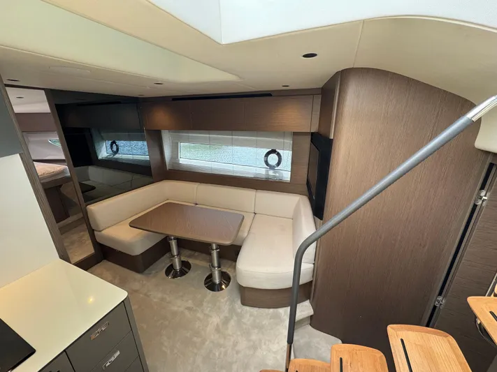 Yacht Photos Pics Luxurious interior of 2023 Princess V50 Open yacht with elegant seating and dining area.