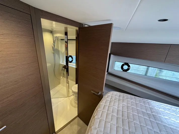  Yacht Photos Pics 2023 Princess V50 Open yacht interior with modern bathroom and cozy bedroom.