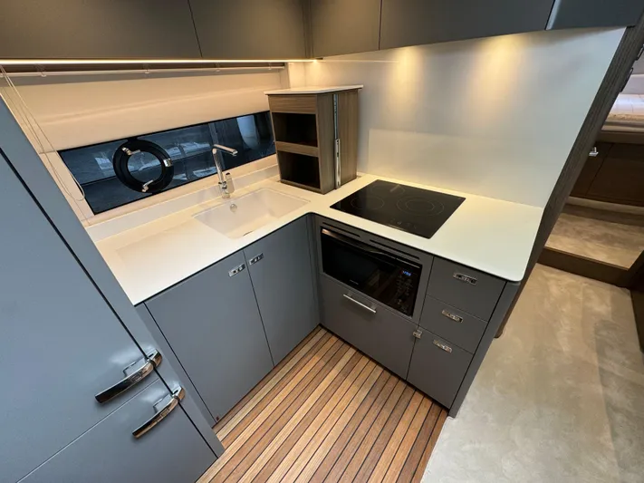  Yacht Photos Pics Modern kitchen in 2023 Princess V50 Open yacht with sleek design and wooden flooring.