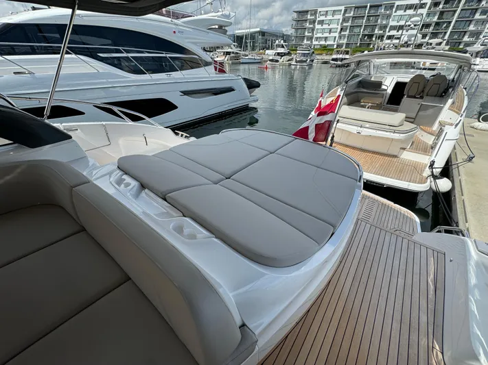  Yacht Photos Pics 2023 Princess V50 Open yacht with sleek design, docked at marina.