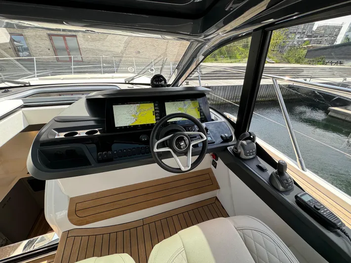  Yacht Photos Pics 2023 Princess V50 Open yacht cockpit with modern navigation system and luxurious seating.