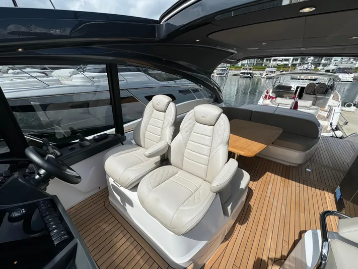  Yacht Photos Pics 2023 Princess V50 Open yacht interior with plush seating and wooden deck.